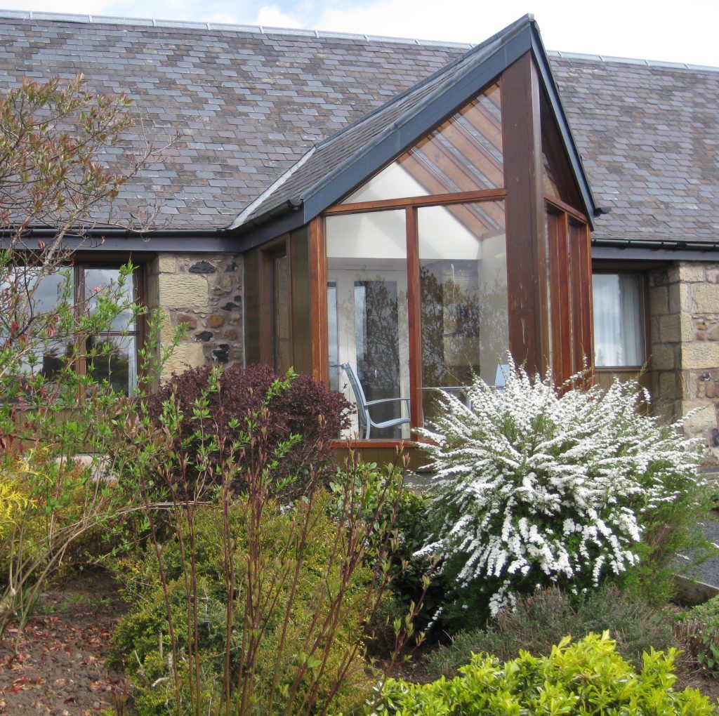 Begrum cottage south facing conservatory overlooking Burnbrae Holidays cottage garden.