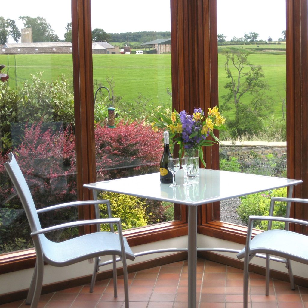 Eat or relax in Begrum Cottage sun room. Admire the views into Burnbrae Holidays garden.