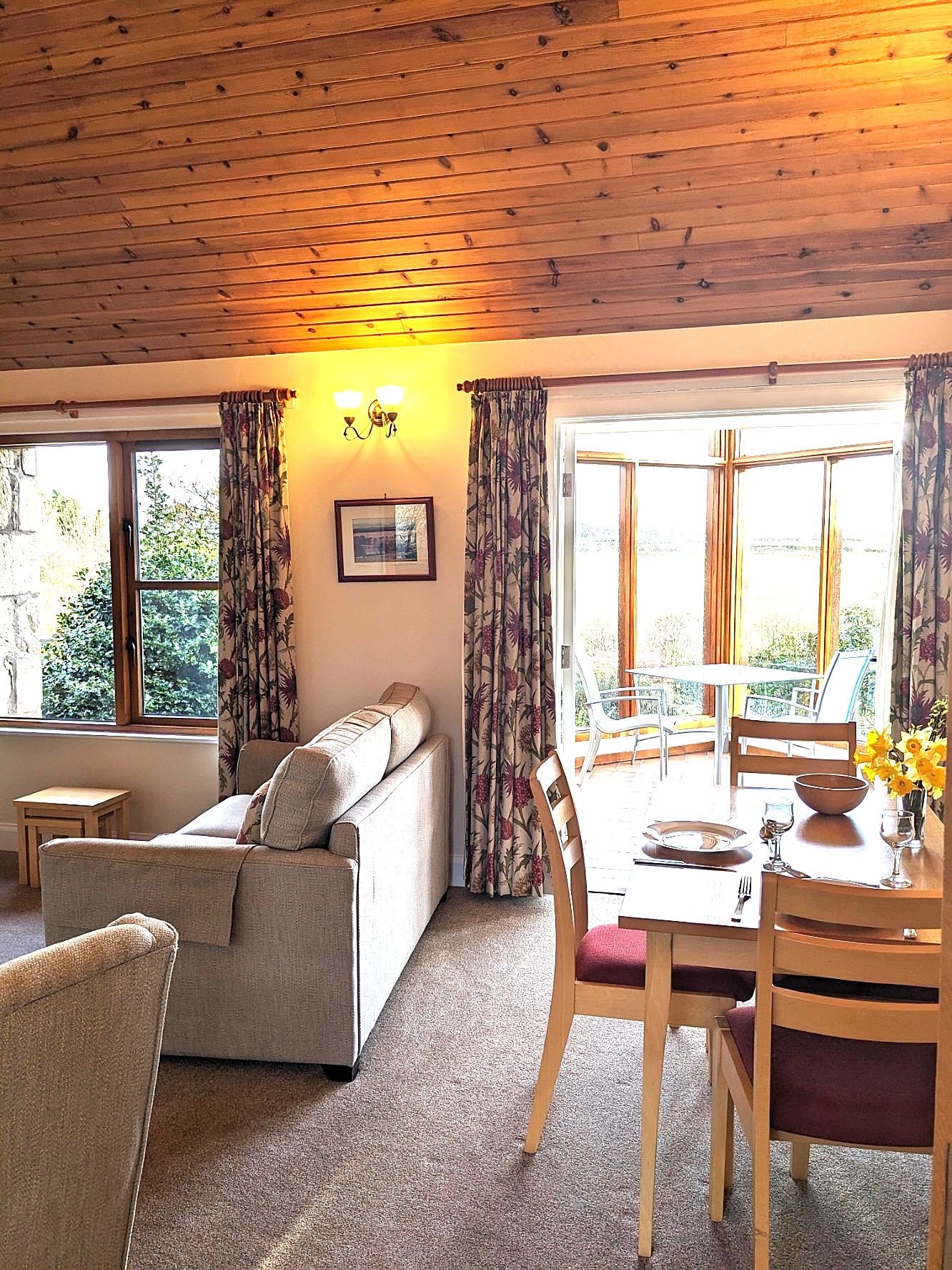 Mungo's Well Cottage living room with dining area, comfy seating level access into conservatory and wonderful views.