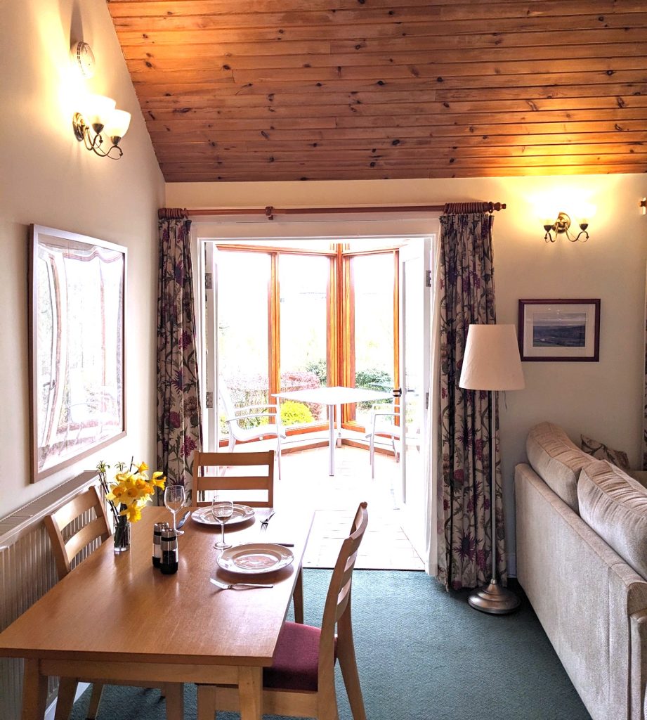 Dog driendly cottage Scottish Borders living room dining area, level access into conservatory. 