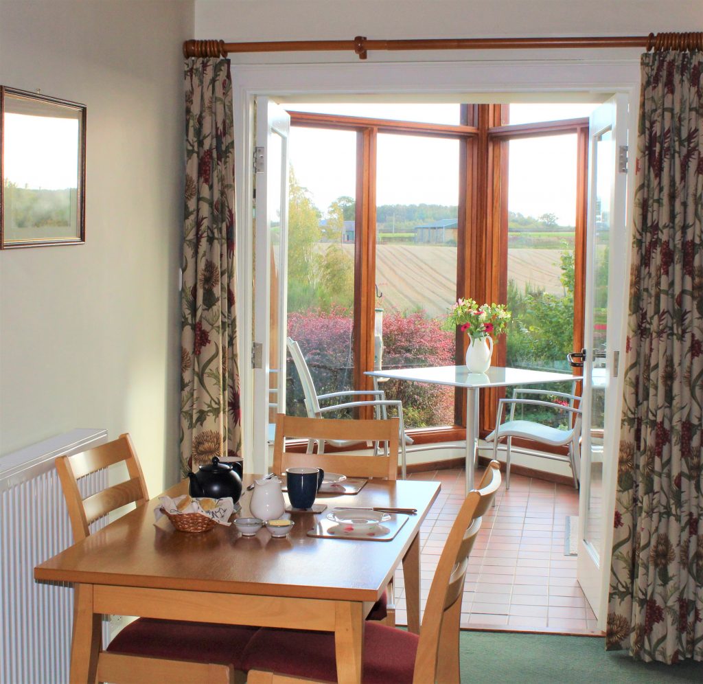 Dining area of Begrum cottage with level access in to conservatory with wonderful rural views