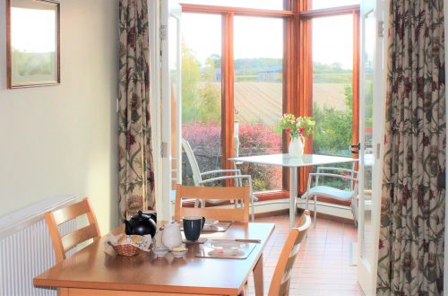 Level access from the dining area in the living room into your south-facing conservatory with amazing views at Burnbrae Holiday cottages